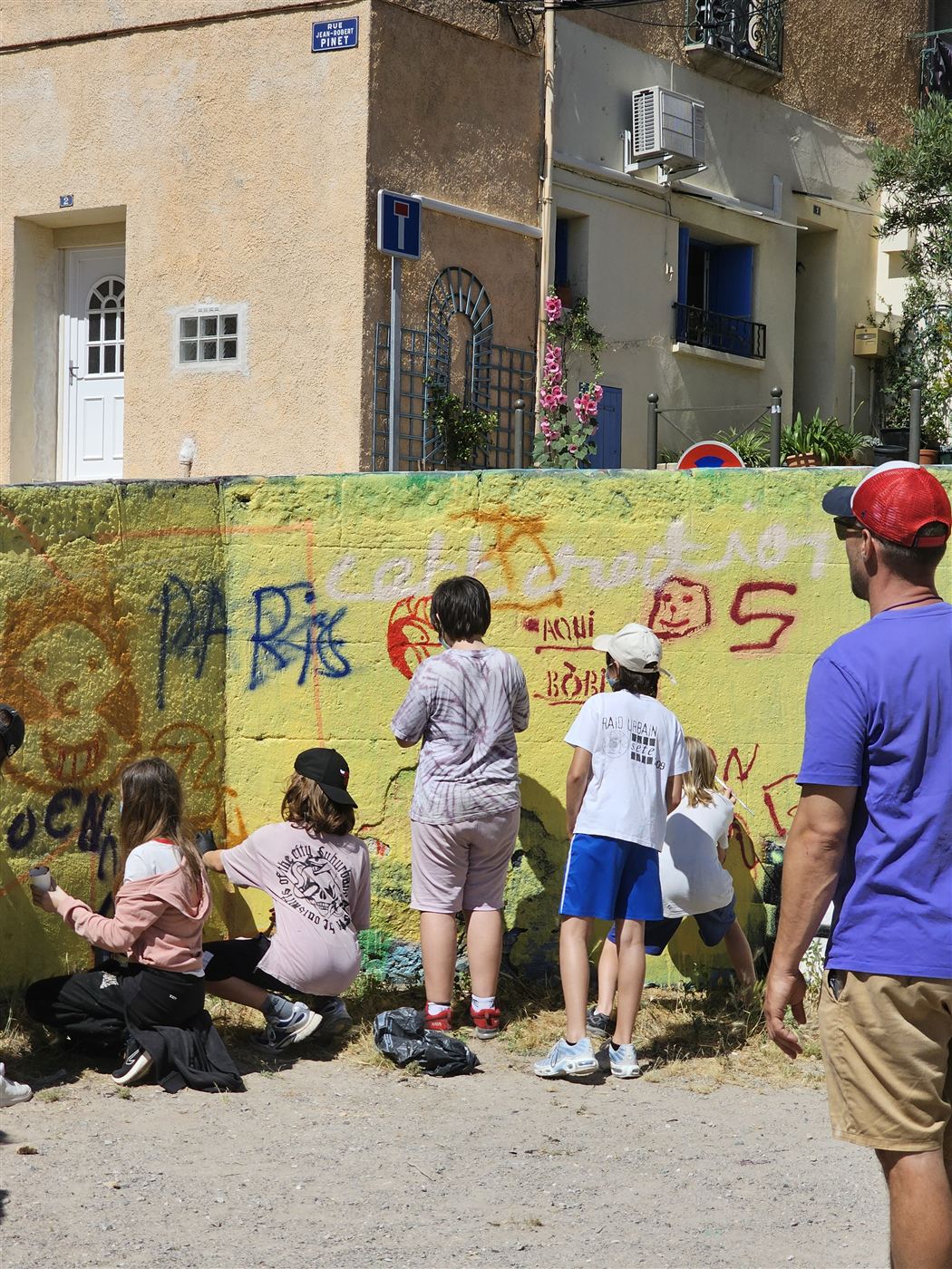 Participants peignant un mur collectif